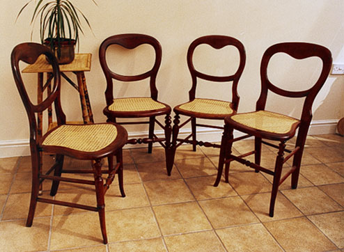 Set of four balloon back cane chairs